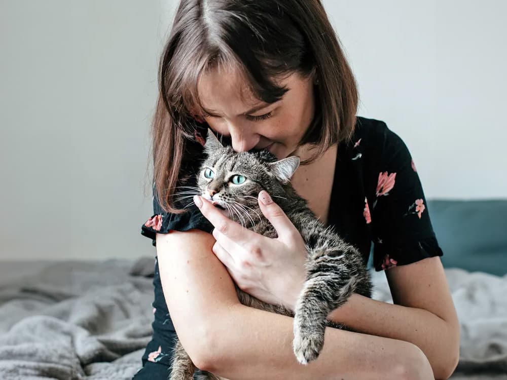 woman thinking about adopting cat